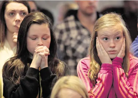  ?? Photo: Declan Doherty ?? PRAY: Fans watch Jason Quigley’s world title fight in the Finn Valley Centre, Co Donegal.