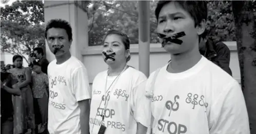  ?? (AP File) ?? In this July 12, 2014, file photo, Myanmar journalist Thet Oo Maung, known as Wa Lone, right, stands with other journalist­s with their mouths taped, symbolizin­g the government's crackdown on media, in Yangon, Myanmar. Under Aung San Suu Kyi, Myanmar...