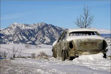  ?? JACK DEMPSEY — THE ASSOCIATED PRESS ?? Snow covers the burned remains of a car after wildfires ravaged the area Jan. 2in Superior, Colo.