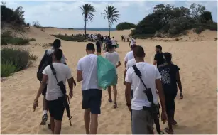  ?? (IDF Spokespers­on’s Unit) ?? TROOPS HEAD toward Zikim Beach after clearing tons of trash from a nearby stream.