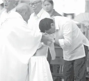  ??  ?? President Rodrigo Duterte greets Davao Archbishop Romulo Valles while attending a 50th wedding anniversar­y rite in 2016 at St. Francis of Assisi Parish in Davao City.