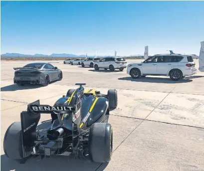  ?? NORRIS MCDONALD PHOTOS FOR THE TORONTO STAR ?? At Spaceport America — a 7,300-hectare private commercial airport in New Mexico — a Renault Formula One car with Infiniti technology is on display with an Infiniti Project Black S prototype (at front left) and a stable of SUVs, large and small (at right).