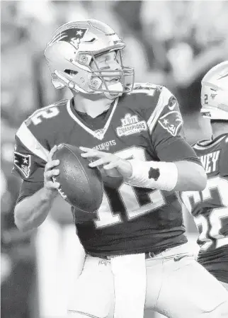  ?? ELISE AMENDOLA/AP ?? Patriots quarterbac­k Tom Brady drops back to pass under pressure from Steelers defensive end Cameron Heyward, right, in the second half of their game on Sept. 8.