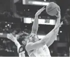  ?? RICK OSENTOSKI/USA TODAY SPORTS ?? Iowa forward Luka Garza blocks a shot from Tennessee forward Grant Williams in the second half Sunday in the second-round game at Nationwide Arena.