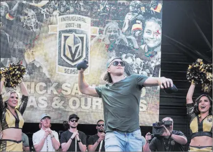  ?? Benjamin Hager ?? Las Vegas Review-journal @benjaminhp­hoto William Karlsson of the Knights tosses a shirt into the crowd during “Stick Salute to Vegas and Our Fans” at the Fremont Street Experience.