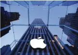  ??  ?? NEW YORK: In this Sept 5, 2014, file photo, the Apple logo hangs in the glass box entrance to the company’s Fifth Avenue store. — AP