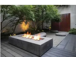  ??  ?? Above The meditative garden at the rear of the house has a very different feel to the other areas. Maples shade the rear garden space, defined by a Corten steel wall feature and a dramatic fire pit.