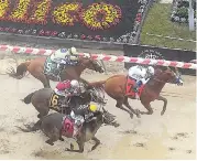  ?? AP ?? Justify (right), with Mike Smith aboard, wins the 143rd Preakness Stakes horse race at Pimlico race track yesterday.