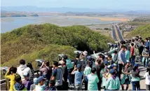  ?? PHOTO: AP ?? Visitors watch the North Korea side from the unificatio­n observator­y in Paju, South Korea, near the border with North Korea.