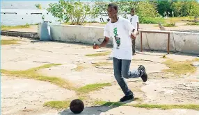  ??  ?? Ian Francis, student of St. George’s College, ends the morning on a fun note as he plays a game of football.