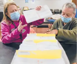  ?? SETH WENIG/AP ?? Election board workers Bernadette Witt, left, and JoAnn Bartlett process and double-check mail-in ballots Wednesday in Hackensack, New Jersey.