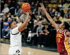  ?? DAVID ZALUBOWSKI — THE ASSOCIATED PRESS ?? Colorado forward Quay Miller, left, shoots for a basket over Southern California center Rayah Marshall during Sunday’s game in Boulder.