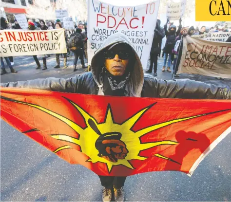  ?? CARLOS OSORIO / REUTERS ?? Protesters gather Sunday on Toronto streets outside the Prospector­s & Developers Associatio­n convention to condemn mining practices.