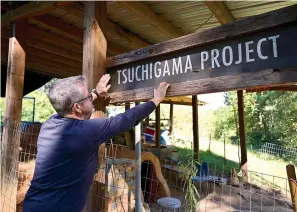  ?? Staff photo by Hunt Mercier ?? ■ Associate professor from Texas Christian University Chris Powell, an associate professor from Texas Christian University, stands outside of his tsuchigama kiln and talks about the project in De Queen, Arkansas.