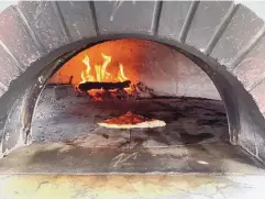  ?? HEATHER HUNTER/ FOR THE JOURNAL ?? Fueled by oak wood, the oven at Bruno’s Pizzeria heats to an impressive 900 degrees.