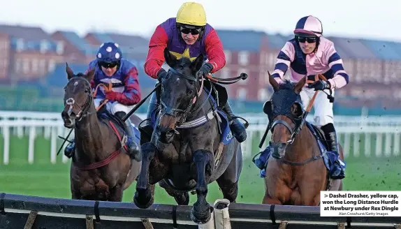  ?? Alan Crowhurst/Getty Images ?? > Dashel Drasher, yellow cap, won the Long Distance Hurdle at Newbury under Rex Dingle