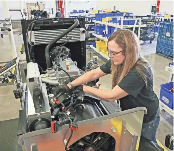  ?? MICHAEL SEARS / MILWAUKEE JOURNAL SENTINEL ?? Kristy Westenberg installs wiring harnesses on 36-kilowatt standby generators at Generac in Whitewater.