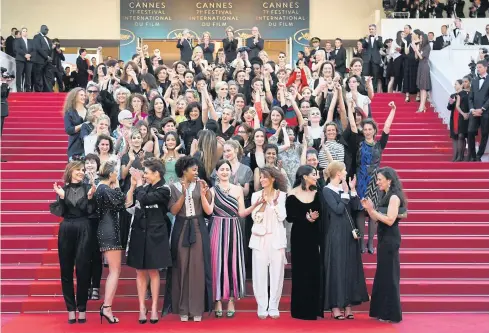  ??  ?? SAD INDICTMENT: Directors, actresses and other industry people pose on the red carpet in protest of the lack of female filmmakers honoured in the history of Cannes.