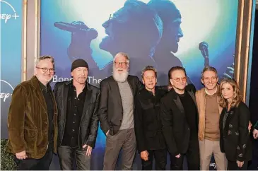  ?? Kevin Winter/Getty Images ?? From left: Morgan Neville, The Edge, Dave Letterman, Brian Grazer, Bono, Justin Wilkes and Sara Bernstein appear at the Los Angeles premiere of the Disney+ Music Docu-Special “Bono & The Edge: A Sort Of Homecoming, with Dave Letterman” at The Orpheum Theatre on March 8.