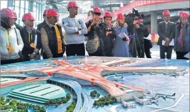  ?? XING YI / CHINA DAILY ?? Foreign journalist­s listen to a presentati­on on progress being made on Beijing’s new airport, south of the city’s center, on Monday. The roof and glass walls are being installed on the main terminal, and trial operations are to begin in October 2019.