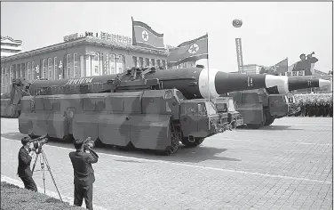  ?? AP/WONG MAYE-E ?? Missiles roll through Kim Il Sung Square during a military parade Saturday in Pyongyang, North Korea. Military experts said they appeared to be KN-08 interconti­nental ballistic missiles, one of three kinds of ICBMs spotted during the parade.
