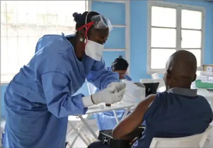  ??  ?? In this photo taken Wednesday a World Health Organizati­on aid worker from Congo gets vaccinated in Mbandaka, Congo. More than 680 people have received Ebola vaccinatio­ns in the three health zones where dozens of cases of the deadly virus have been...