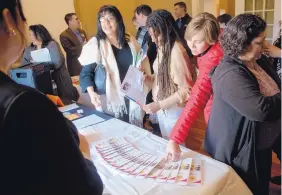  ?? MARLA BROSE/JOURNAL ?? Sara Carrillo, second from right, from George I. Sanchez Collaborat­ive Community School; Jinx Baskervill­e, third from right, principal at New Futures High; and Denise Balderas, fourth from right, principal at Adobe Acres Elementary, get informatio­n...