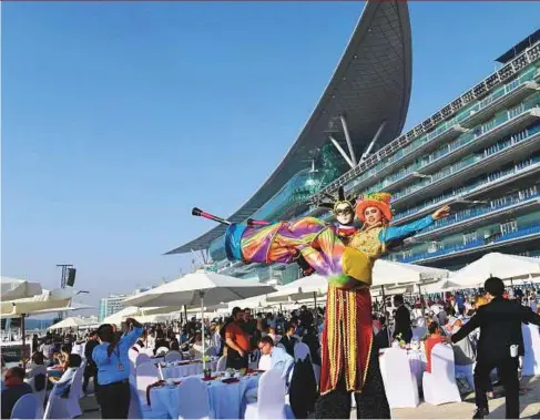  ??  ?? ■ Performers entertain guests during the Breakfast With The Stars ahead of the Dubai World Cup at Meydan Racecourse yesterday.