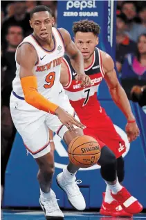  ?? ASSOCIATED PRESS FILE PHOTO ?? Knicks’ RJ Barrett, left, brings the ball up the floor Oct. 11 as Washington Wizards’ Justin Anderson trails in New York.