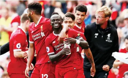  ??  ?? Liverpool players celebrate their win over Arsenal in the English Premier League recently