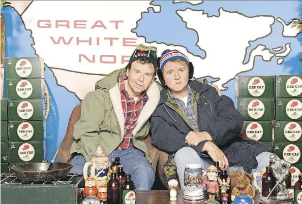  ?? CBC. ?? Bob McKenzie (Rick Moranis), left, and Doug McKenzie (Dave Thomas) have made it clear that the first day of Christmas means beer.