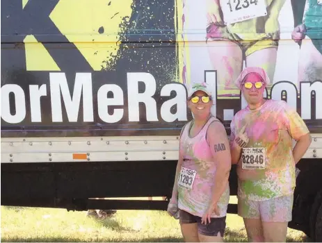  ?? SUBMITTED PHOTOS ?? Mona Ford, left, and her yoga instructor, Amy Thiele, were hit by a color bomb at Color Me Rad 5K on June 15. The event was Ford’s first 5K, though she has participat­ed in two others since then.