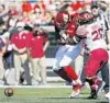  ?? JOE ROBBINS/GETTY ?? FSU’s DeCalon Brooks, right, knocks the ball out of the hands of Louisville quarterbac­k Jawon Pass during the Seminoles’ win Saturday at Cardinal Stadium.