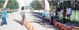  ?? CONTRIBUTE­D ?? Kingston College’s Arymanya Rodgers crosses the finish line to win the G.C. Foster College 5k Road Race in a time of 15:22.18 seconds yesterday.