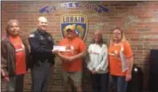  ?? KEVIN MARTIN — THE MORNING JOURNAL ?? Lorain Fraternal of Police (FOP) President Kyle Gelenius from accepts a $2,300 donation from the Black River Browns Backers handed from President Robert “Ozzie” Osburn at the Lorain Police Department at 200 W. Erie Ave. on Oct. 27.