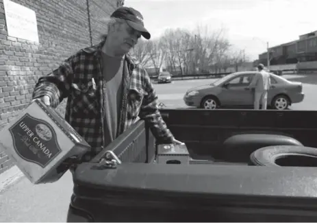  ?? MARTA IWANEK/TORONTO STAR ?? Ray Anderson packs beer into his truck in front of The Beer Store near Queen St. E. and Leslie St. "I don’t really care," he said when asked about the changes. "I’m more worried about the price increase that’s coming up."