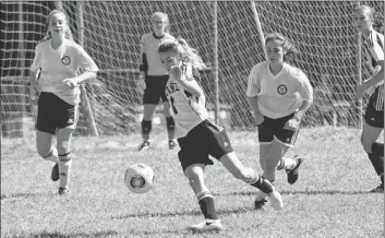  ??  ?? NKEC’S Emily Bennett looks to gain control of an incoming ball while under pressure in a tough match against Horton.