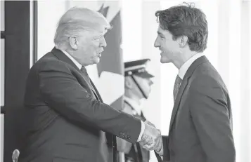  ?? ANDREW HARNIK, AP ?? President Trump welcomes Canadian Prime Minister Justin Trudeau outside the West Wing of the White House on Monday. It marked the two leaders first face- to- face meeting.