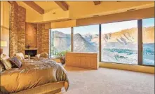  ?? A BEDROOM, ?? one of five in the house, boasts expansive views.