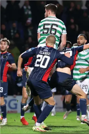  ?? ?? Anthony Ralston leaps highest to power home a header and seal all three points for Celtic in the Highlands last night
