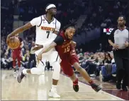  ?? RON SCHWANE — THE ASSOCIATED PRESS ?? Nuggets guard Reggie Jackson plays against Cavaliers guard Darius Garland during the first half on Thursday in Cleveland.