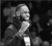  ?? Associated Press ?? RESURGING Los Angeles Lakers injured guard LeBron James cheers his team during the first half of an NBA basketball game against the Denver Nuggets on Sunday in Los Angeles.