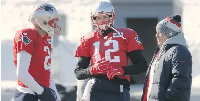  ?? STEVEN SENNE / THE ASSOCIATED PRESS ?? Patriots quarterbac­ks Brian Hoyer, left, and Tom Brady, centre, with head coach Bill Belichick during practice Thursday in Foxborough. Brady didn’t take part in the practice part of the session due to an injured hand.