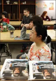  ?? NWA Democrat-Gazette/DAVID GOTTSCHALK ?? Zhiwen Xu, a senior at Fayettevil­le High School, listens to a presentati­on about the University of Arkansas School of Art earlier this month. She said she would consider going to UA because of the number of new scholarshi­ps.