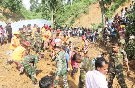  ??  ?? Rescuers search for survivors and bodies after Tuesday’s massive landslide in Rangamati district, Bangladesh, on Wednesday. (AP)