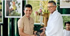  ??  ?? From left: Environmen­talist and author Chaminda Jayasekara handing over the first copy to the Jetwing Hotels Chairman Hiran Cooray