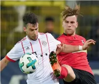  ?? AP ?? Munich’s Juan Bernat (left) and Freiburg’s Lucas Hoeler challenge for the ball during the Bundesliga match. —