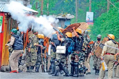  ?? AFP ?? Security forces fire teargas during the clashes with supporters of the separatist Gorkha Janmukti Morcha group in Darjeeling. —