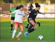  ?? Kena Betancur AFP/Getty Images ?? SKY BLUE and national team forward Carli Lloyd, right, battles Washington midfielder Jordan DiBiasi.