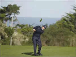  ?? The Associated Press ?? Phil Mickelson hits his approach shot from the second fairway during the second round of the AT&amp;T Pebble Beach National Pro-Am on Friday in Pebble Beach, Calif.